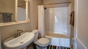A bathroom with a sink, toilet, and bathtub. - Downtown Bozeman Apartment Above Main Street, Monthly + Extended Stays (Bozeman)