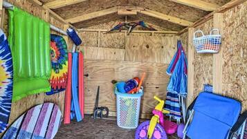 Storage room with a functional layout, featuring a variety of colorful items and a small basket.