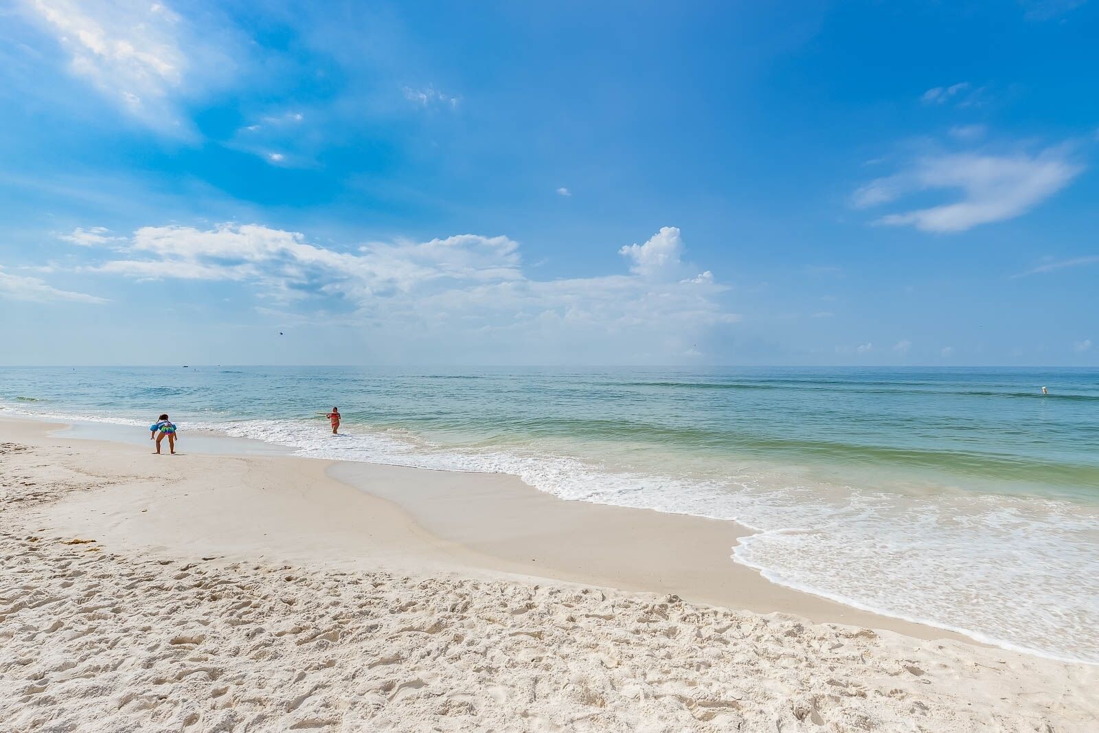 A beach with clear skies and calm waters.