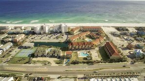 An aerial view of a coastal hotel with multiple buildings, a swimming pool, and a beach in the background. - 🌞 4.5 Bedroom 3 Bath townhome with 2 community pools 🏖️ (Pensacola Beach)