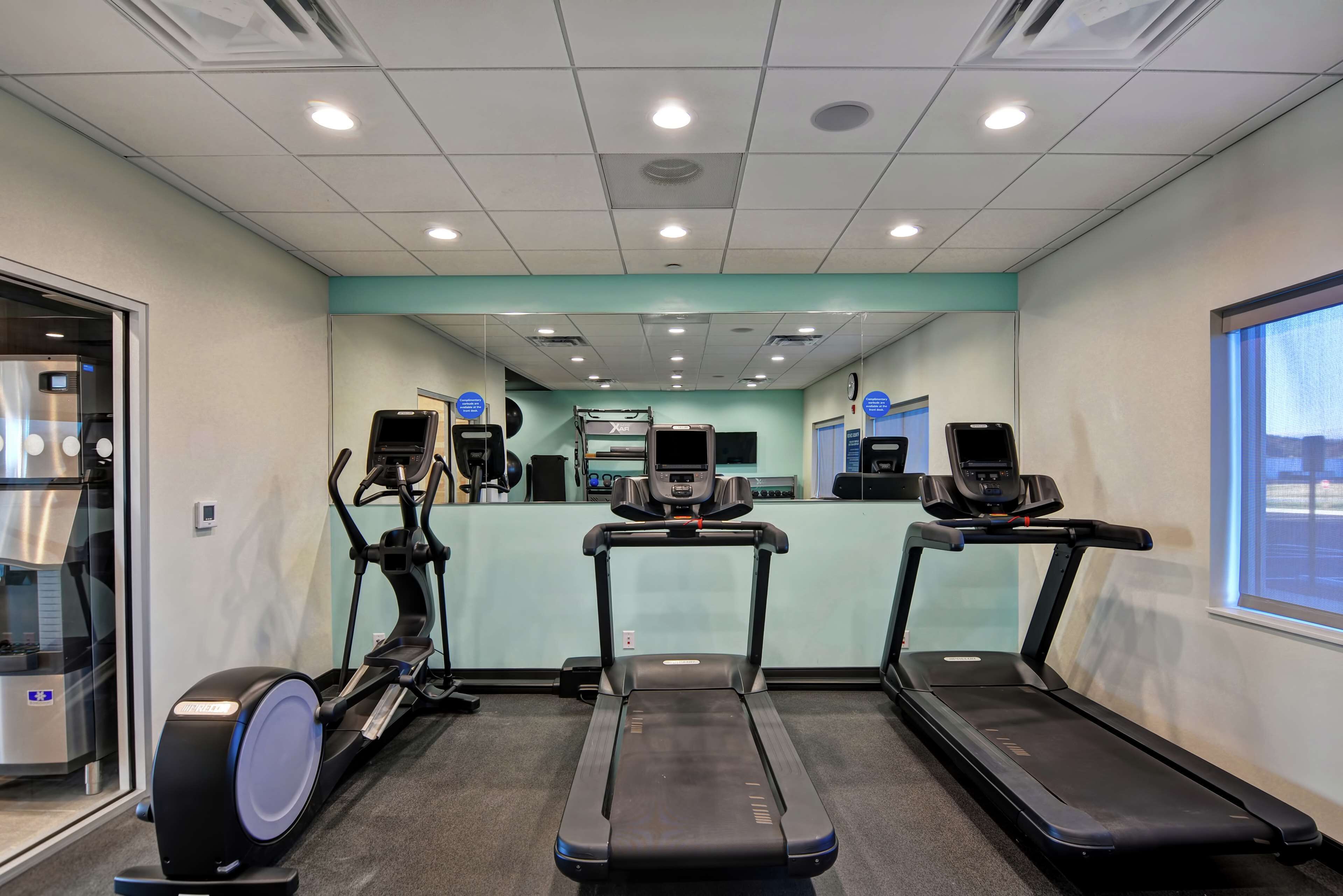 A fitness center with treadmills, an elliptical, and a stationary bike.
