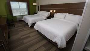 A hotel room with two beds, a desk, a chair, and a large window offering a view.