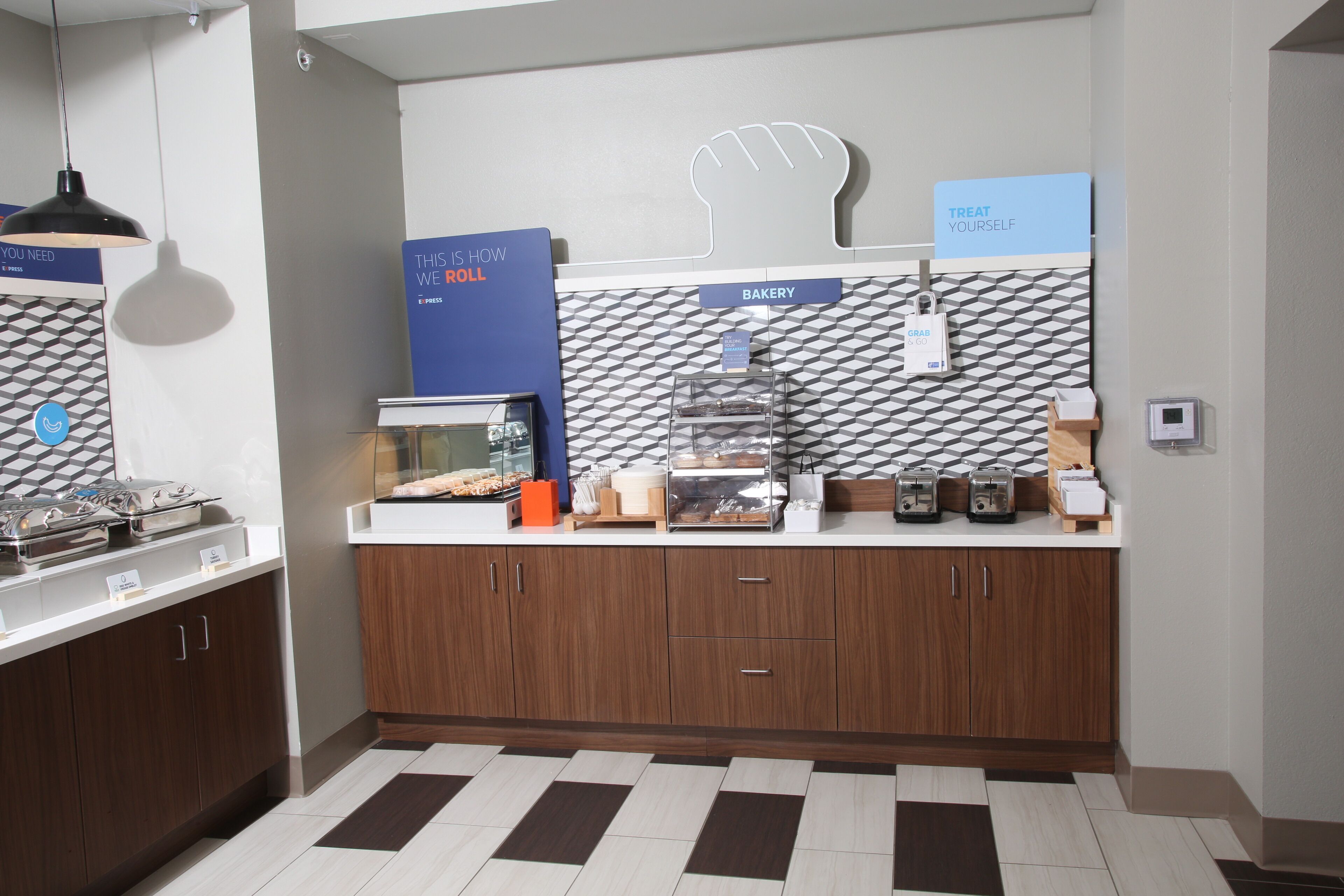 A modern kitchen with a bakery section, a coffee station, and a self-serve grab-and-go area.