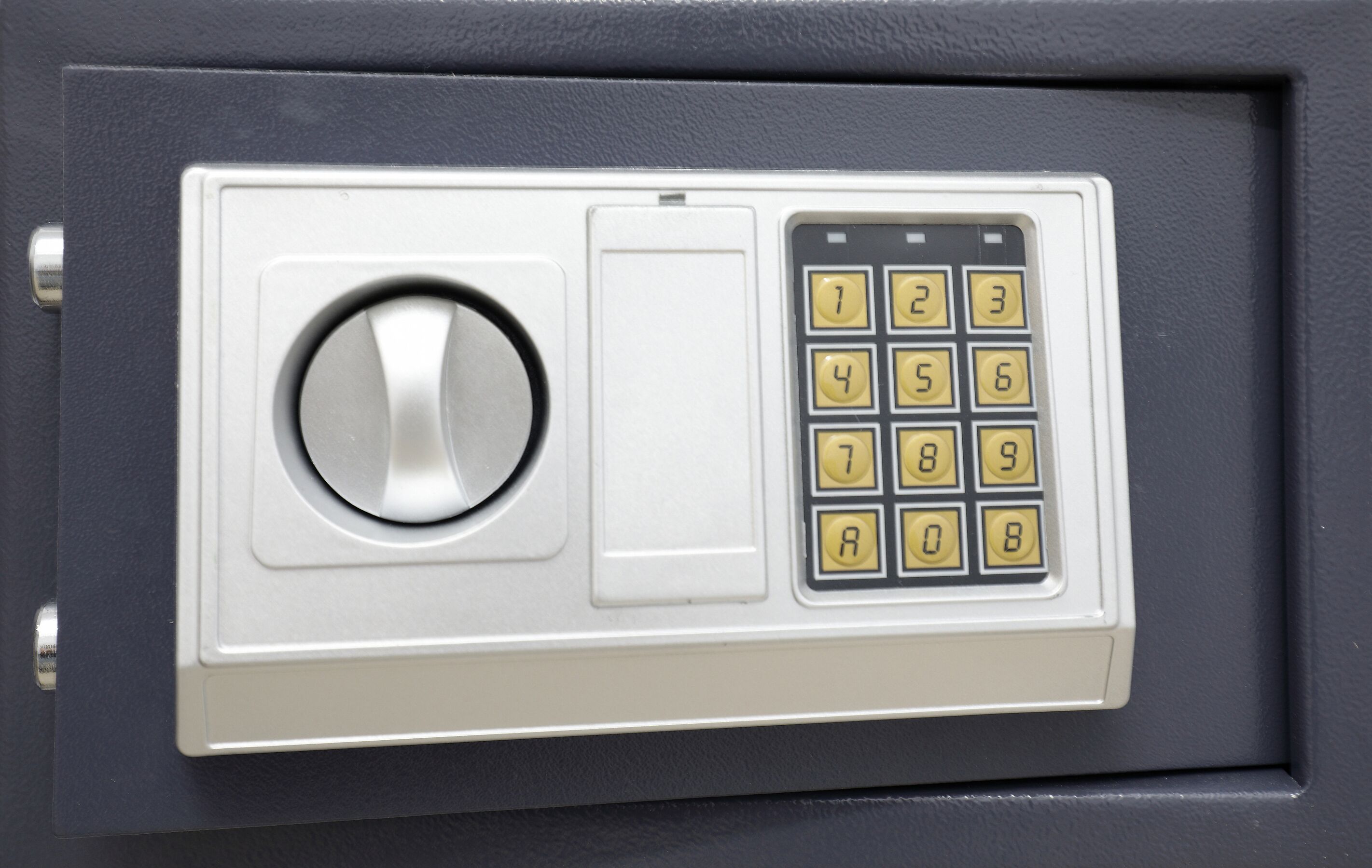 A safe with a combination dial and a keypad.