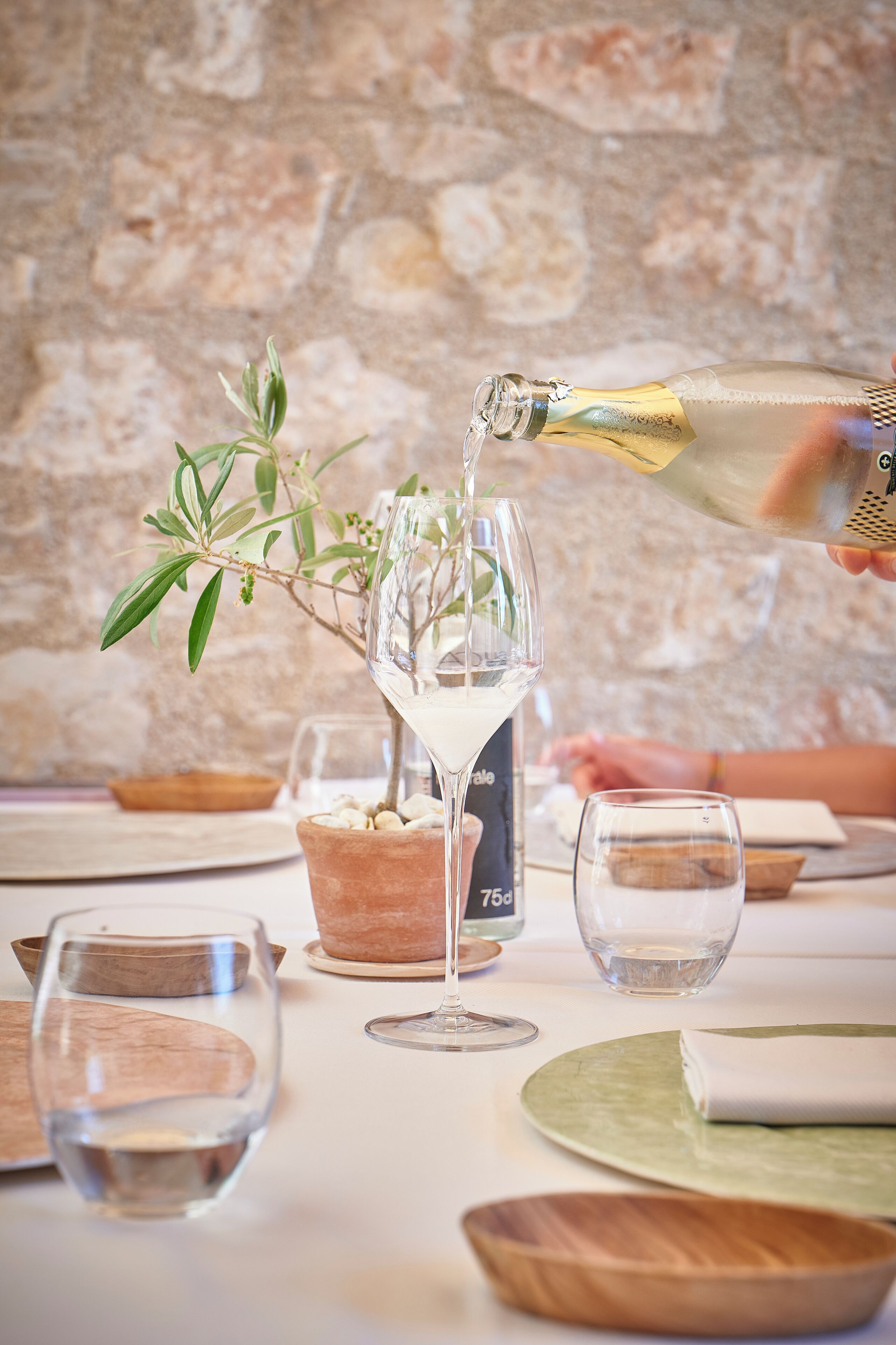 A bottle of champagne being poured into a glass.