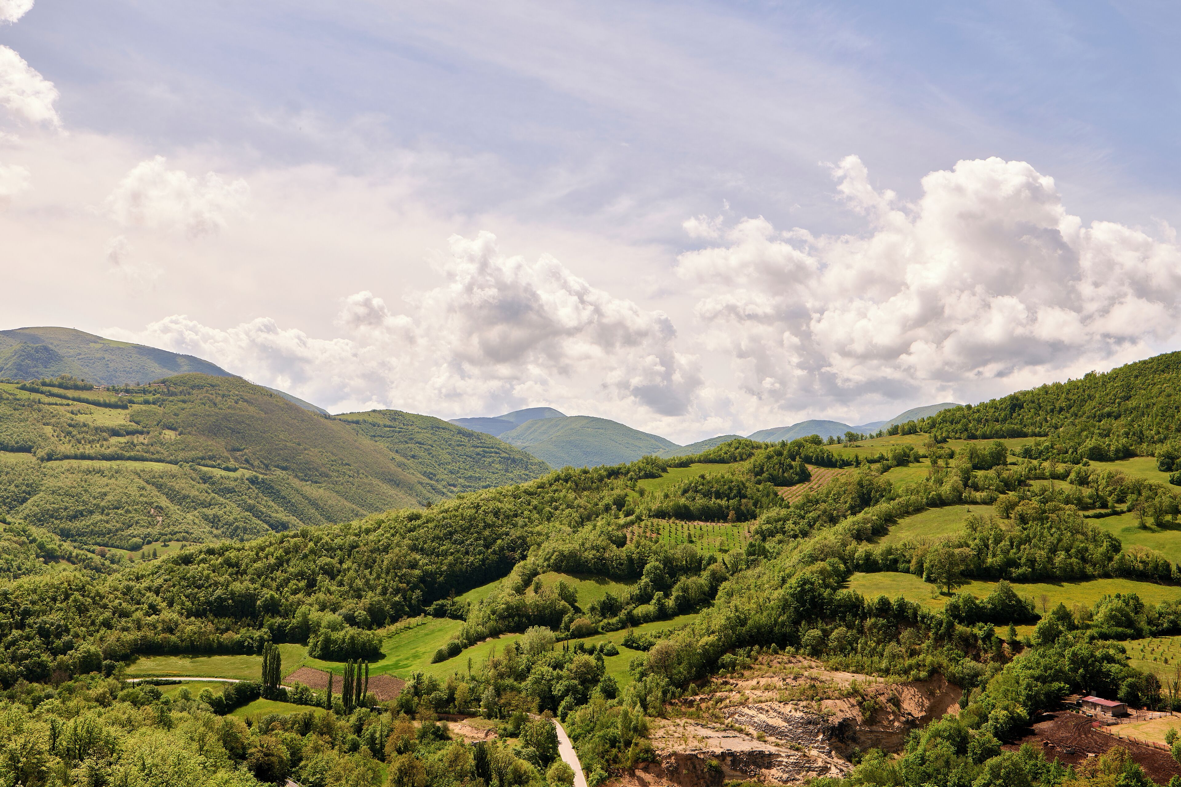 A lush green landscape with rolling hills and a clear sky.