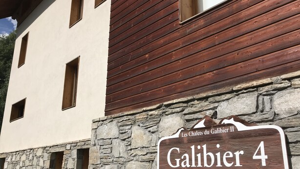 A sign for "Les Chalets du Galibier II, Galibier 4" indicating a chalet-style accommodation.