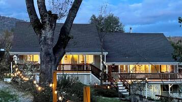 A two-story house with a porch and a staircase leading to the upper level.