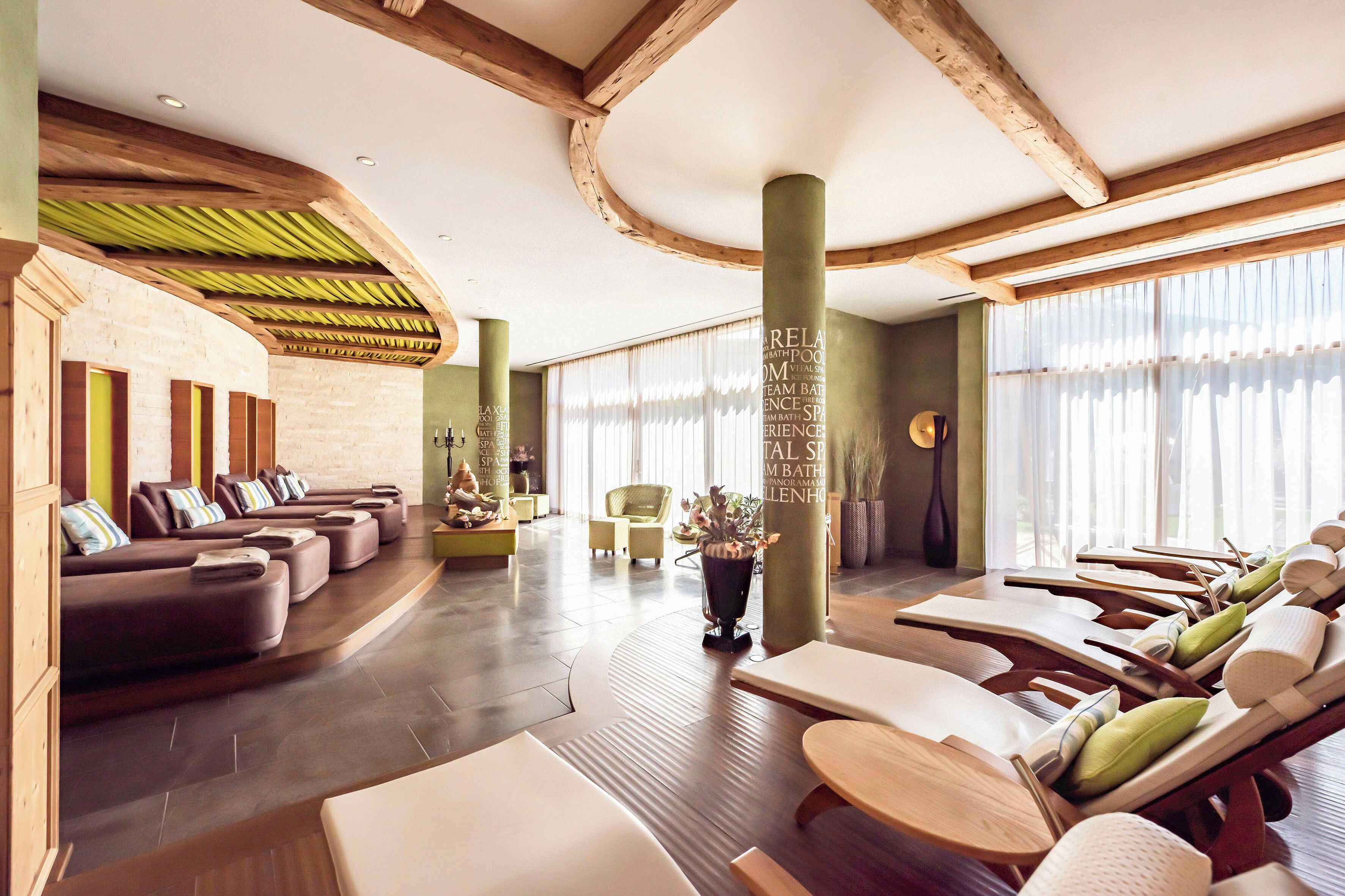 A spa area with massage chairs and a relaxation area with sofas and a small table.