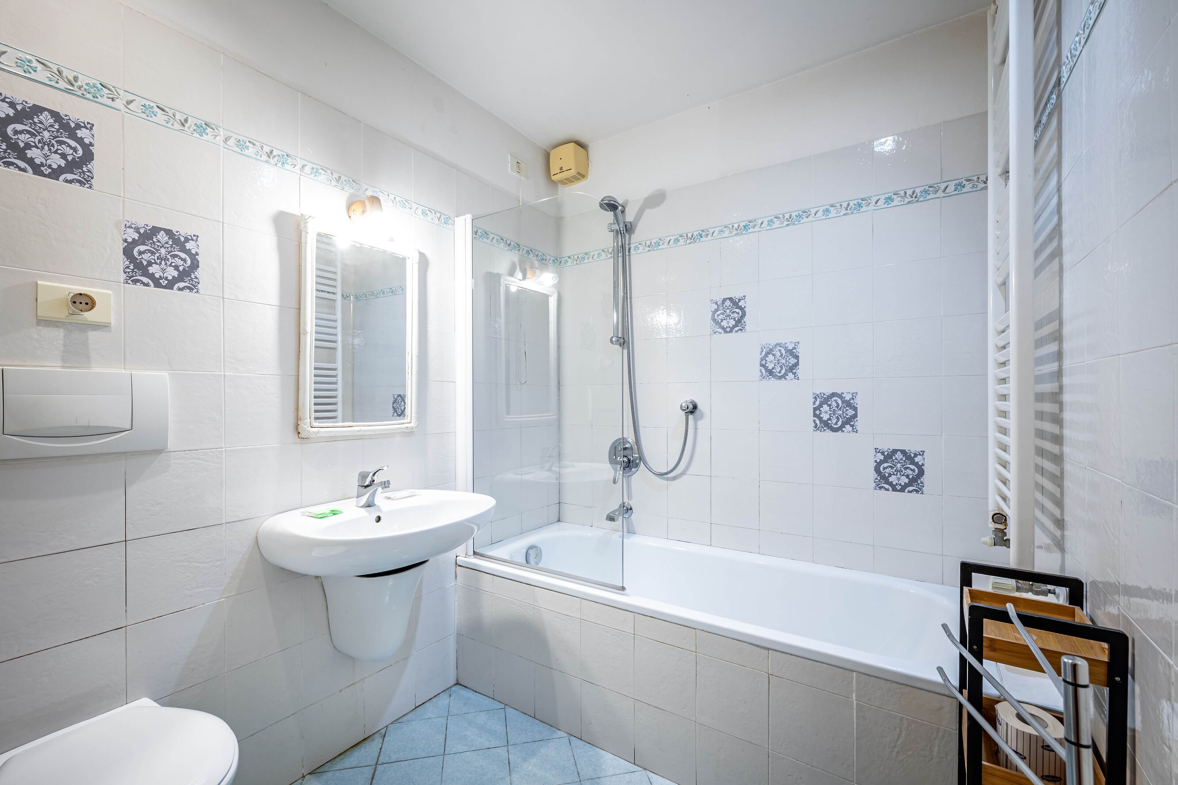 A bathroom with a white sink, a toilet, and a bathtub.