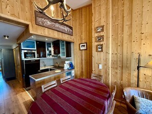 Une chambre confortable avec un lit, un bureau et une kitchenette.