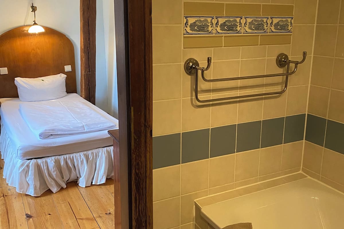 single room | bathroom | bathtub, hair dryer, towels