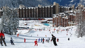 A ski resort with multiple buildings, a ski slope, and a pool area. - 2-room apt for 5 in station center with balcony and pool (Plagne Bellecôte)