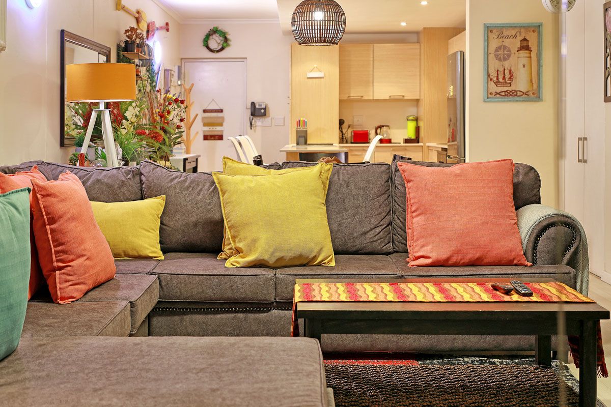 A living room with a sofa set, a coffee table, and a rug.