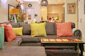 A living room with a sofa set, a coffee table, and a rug. - Horizon Bay 1201 (Cape Town)