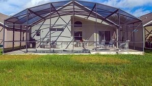 A large, semi-open structure with a glass roof, possibly a greenhouse or conservatory, with a patio area in front. - Ly239890 - Emerald Island Resort - 4 Bed 3 Baths Villa (Kissimmee)