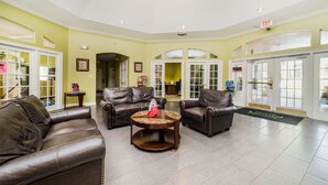 A lobby with leather sofas, a coffee table, and a reception desk. - Ly239890 - Emerald Island Resort - 4 Bed 3 Baths Villa (Kissimmee)