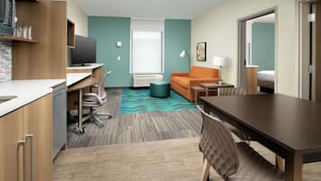 Desk, iron/ironing board, bed sheets