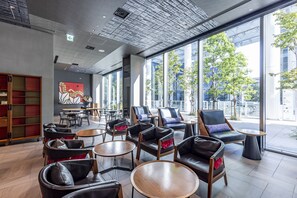 Relax in a stylish space with comfortable seating and large windows offering views of the outdoors.