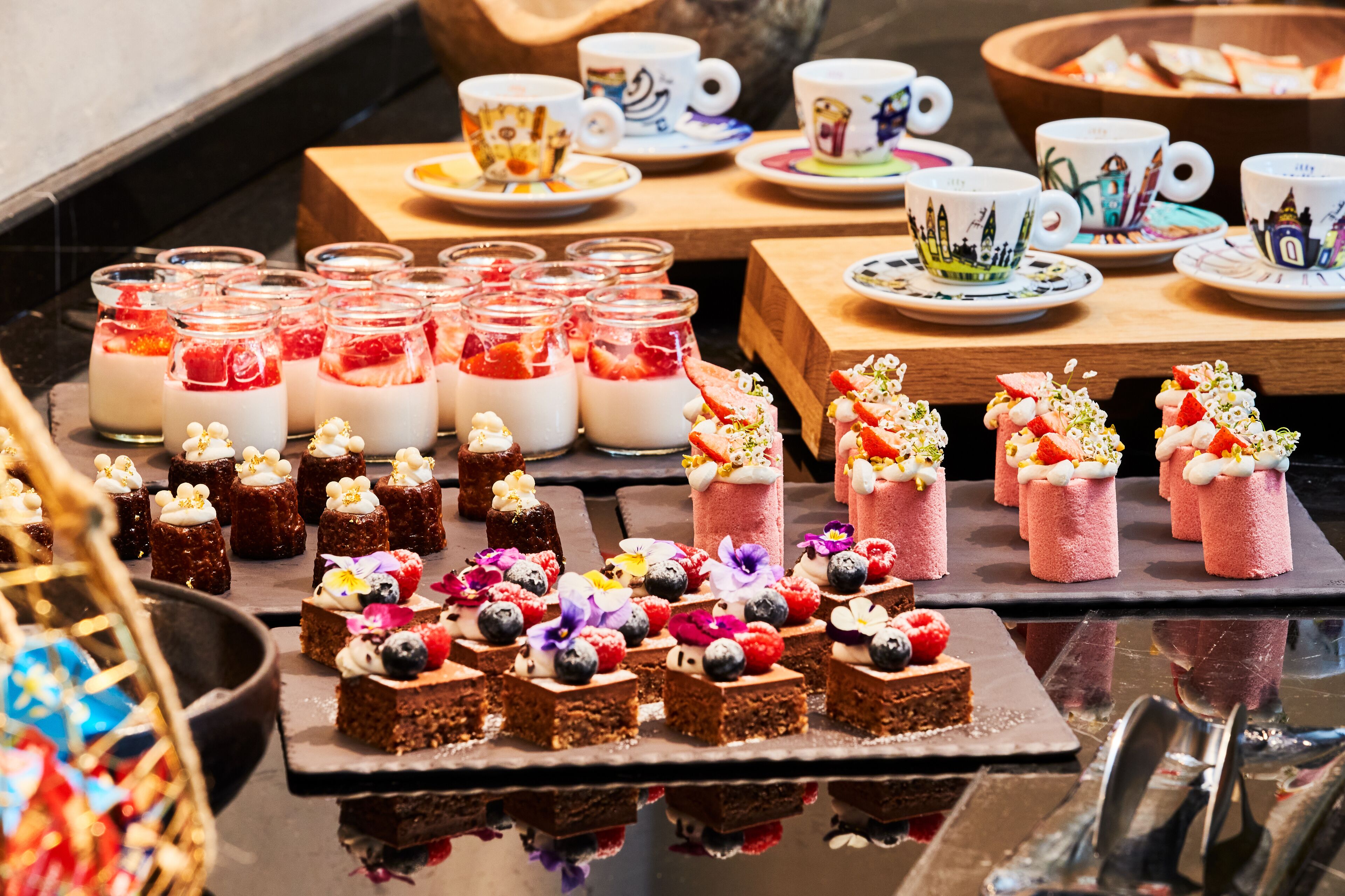 A dessert display with various sweets and a tea service.