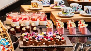 A dessert display with various sweets and a tea service.
