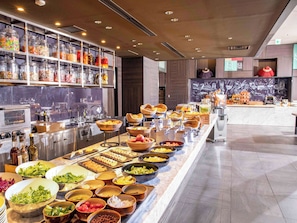 Indulge in a diverse selection of international cuisine at our buffet, featuring fresh salads, fruits, and a variety of prepared dishes.