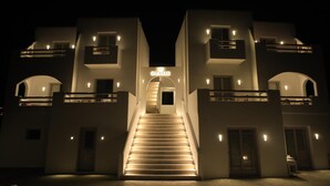 A modern building with a central staircase leading to an entrance. - Theasis Luxury Suites (Naxos)