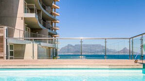 A modern hotel with a pool and a view of the ocean. - Horizon Bay 1602 (Cape Town)