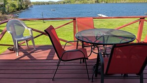 A deck with a table and chairs overlooking a lake. - Lakefront Cottage w/Breathtaking Views! Hiking.PaddleBoat.Doc.Fishing.WiFi (Wells)