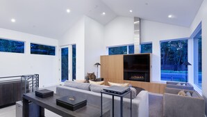A modern living room with a sofa, coffee table, and entertainment unit.