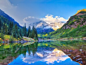 A mountain landscape with a clear lake reflecting the scenery.