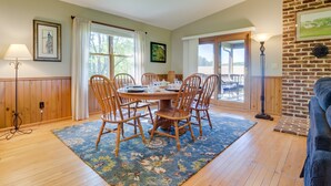 A dining area with a round table, wooden chairs, and a blue floral rug. - 2 Mi to Wineries: Calm Cottage on 90 Acres w/ Barn (Stewartstown)