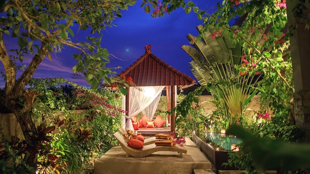A gazebo with a bed, surrounded by lush greenery and a night sky. - Zara The Bali Ocean View (Badung)