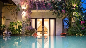 A poolside view of a hotel with a clear glass pool reflecting the surroundings. - Zara The Bali Ocean View (Badung)