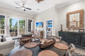 A dining area with a round table, woven placemats, and a decorative bowl.
