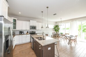 Enjoy cooking in this well-equipped kitchen with a central island, sink, and ample counter space.