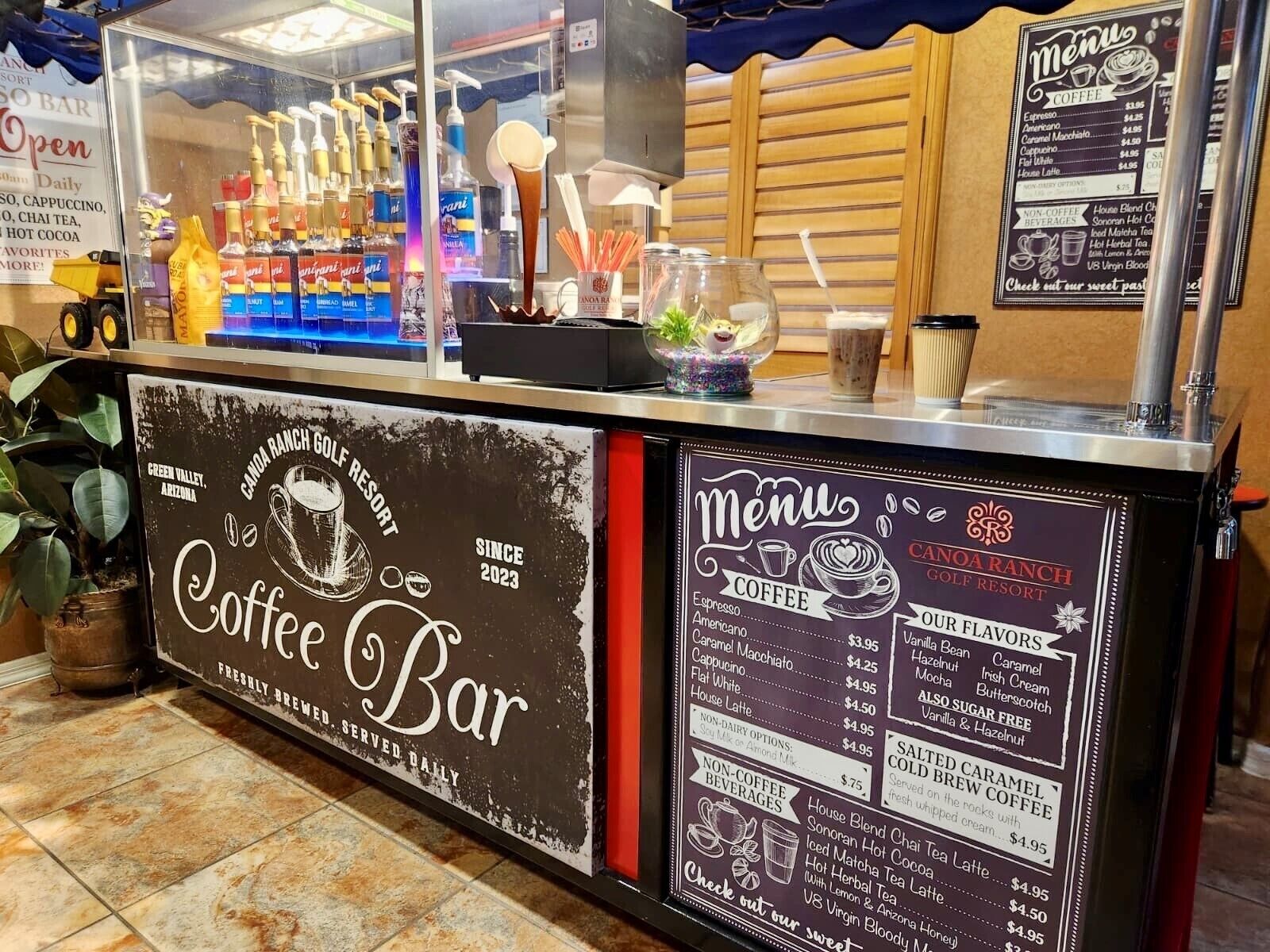A coffee bar with a menu board listing coffee and non-coffee beverages.