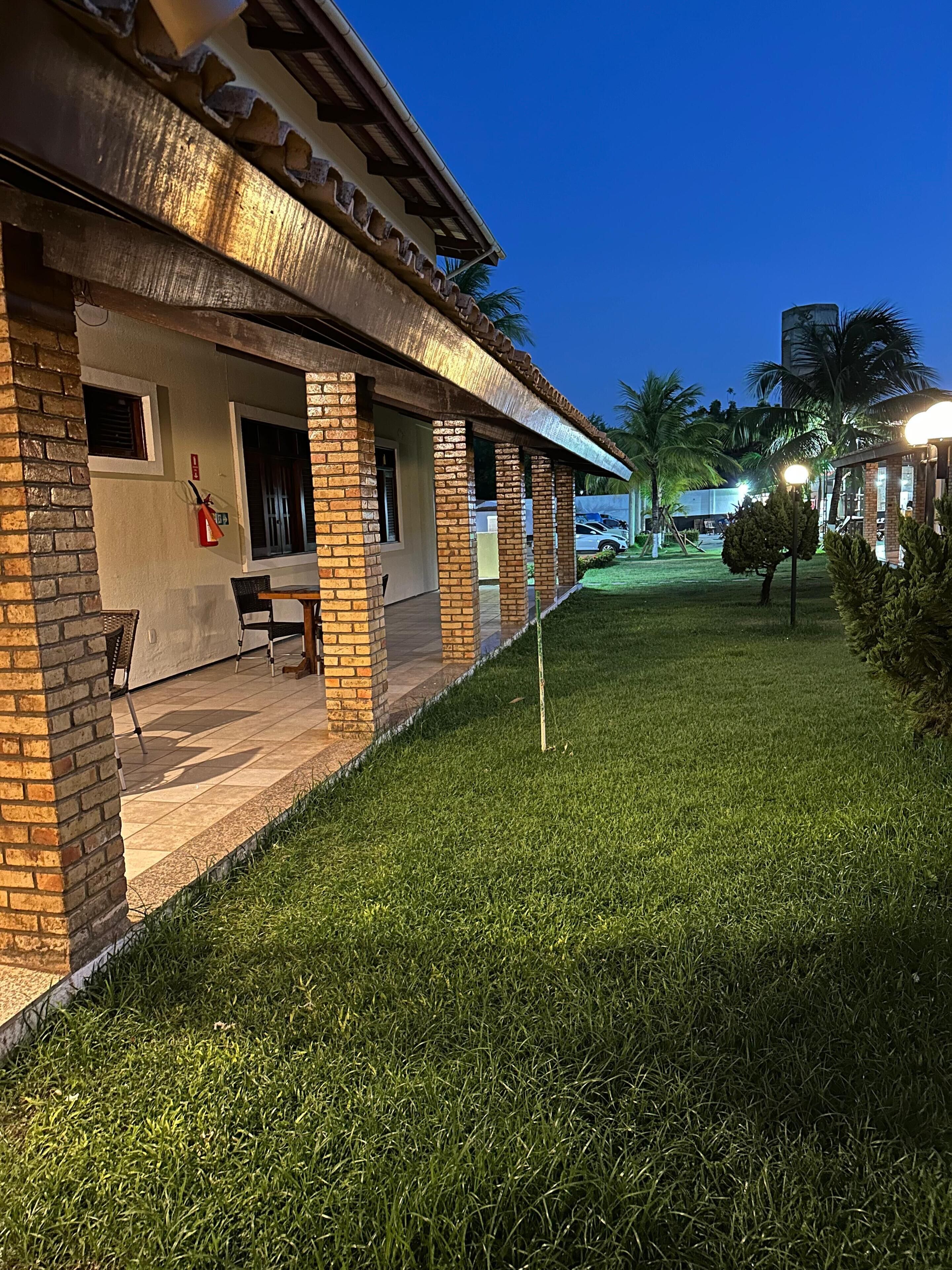 A building with a brick facade and a covered patio area.
