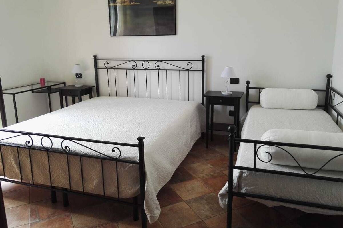 Family Triple Room, Garden View | Minibar, in-room safe, desk, soundproofing