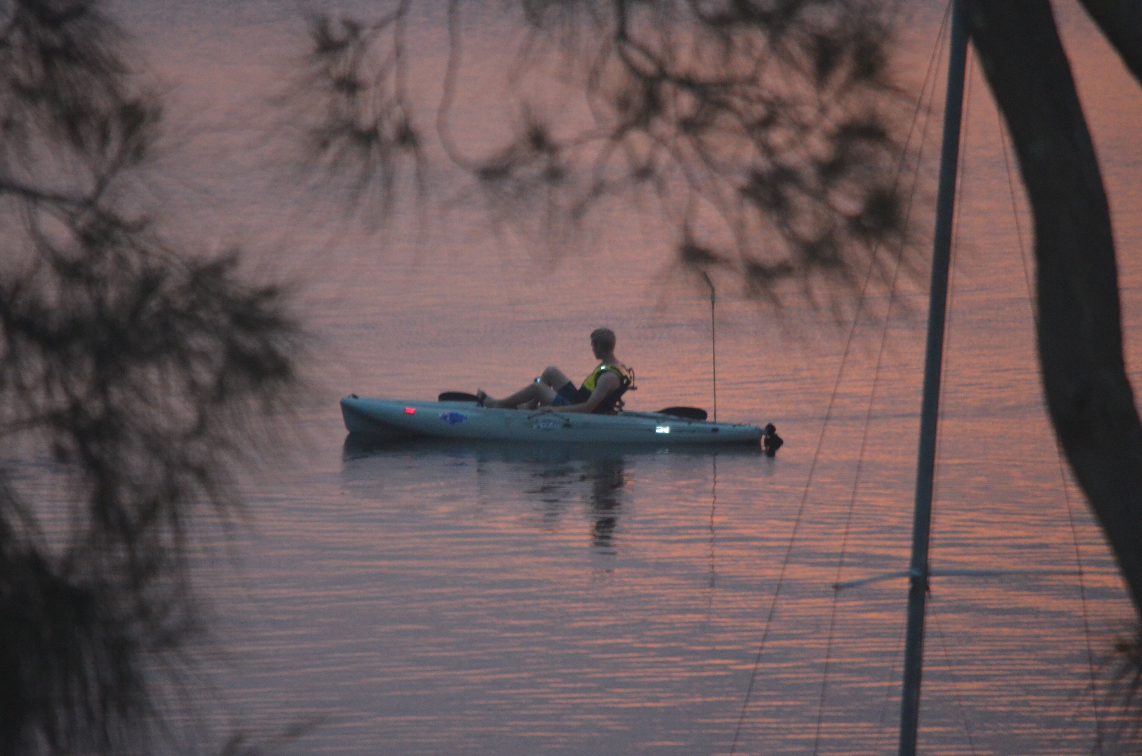 A person in a kayak on a body of water.