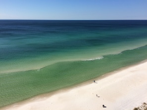 A beach with clear water and a sandy shore.