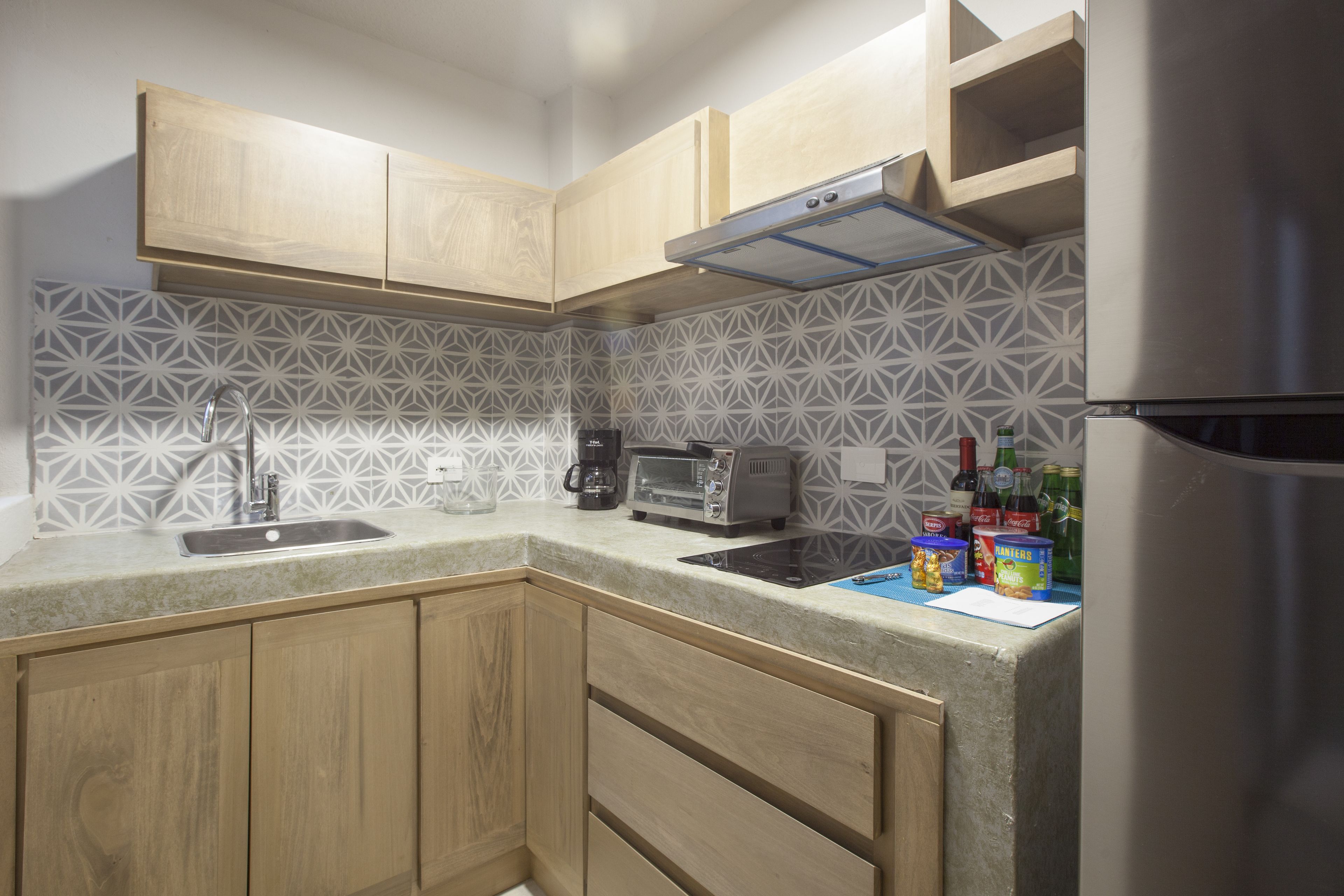 full-sized fridge, stovetop, toaster oven, cookware/dishes/utensils