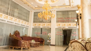 A luxurious lobby with ornate furniture, a grand chandelier, and decorative ceiling details. - Anh Nguyet Hotel (An Xuyen)