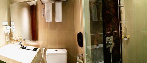 A modern bathroom with a sink, toilet, and glass-enclosed shower.