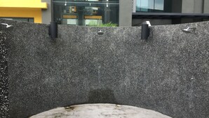 A modern building with a textured facade and a reflective glass window. - Silk Sky Residence (Seri Kembangan)