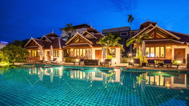 A hotel with a swimming pool, multiple guest rooms, and a well-lit outdoor area. - Achawalai By PP (Pattaya)