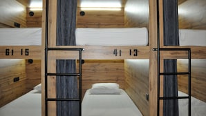 A bunk bed room with wooden walls and a metal ladder. - Full House Capsule Hostel (Rivne)