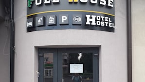 A Full House Hotel Hostel sign with icons indicating bed, shower, parking, and Wi-Fi. - Full House Capsule Hostel (Rivne)