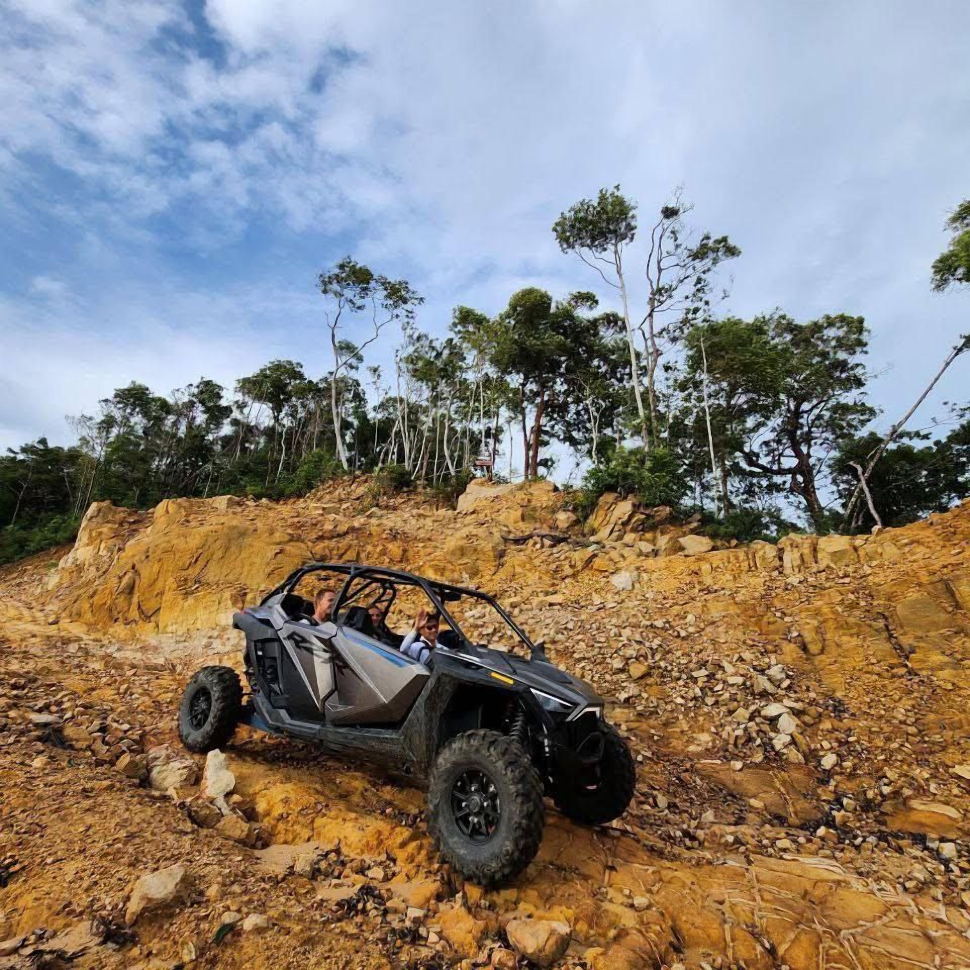 A vehicle on a rocky terrain with trees in the background.