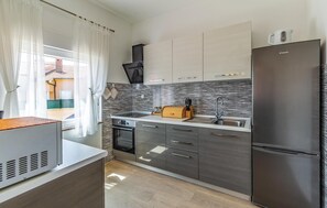 Fridge, stovetop, dishwasher, coffee/tea maker